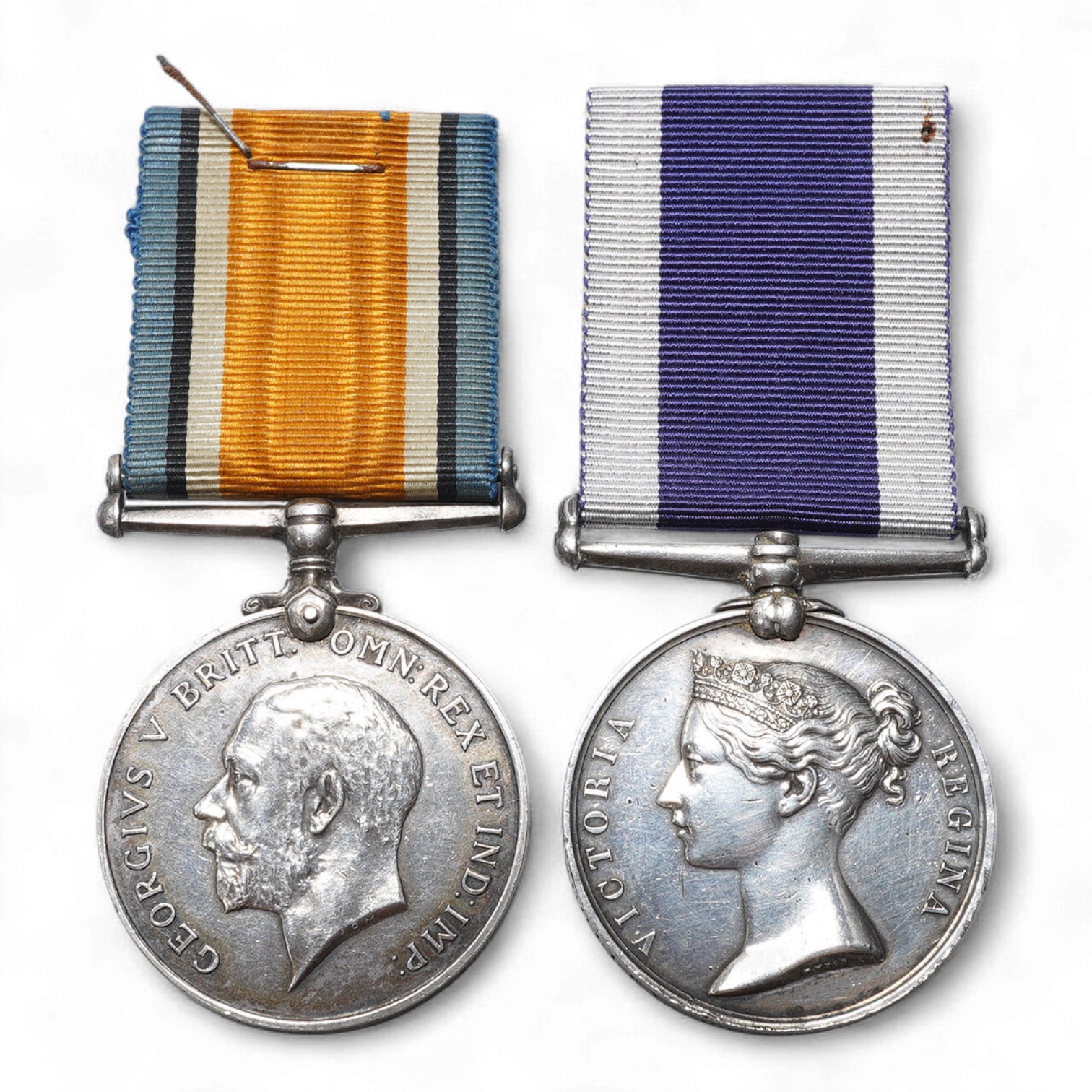 A Victoria and GV medal pair awarded to George S. Woolley, Boatman, H.M. Coast Guard, comprising of a Victoria Royal Naval Long Service and Good Conduct medal and a GV First World War 1914-1918 medal